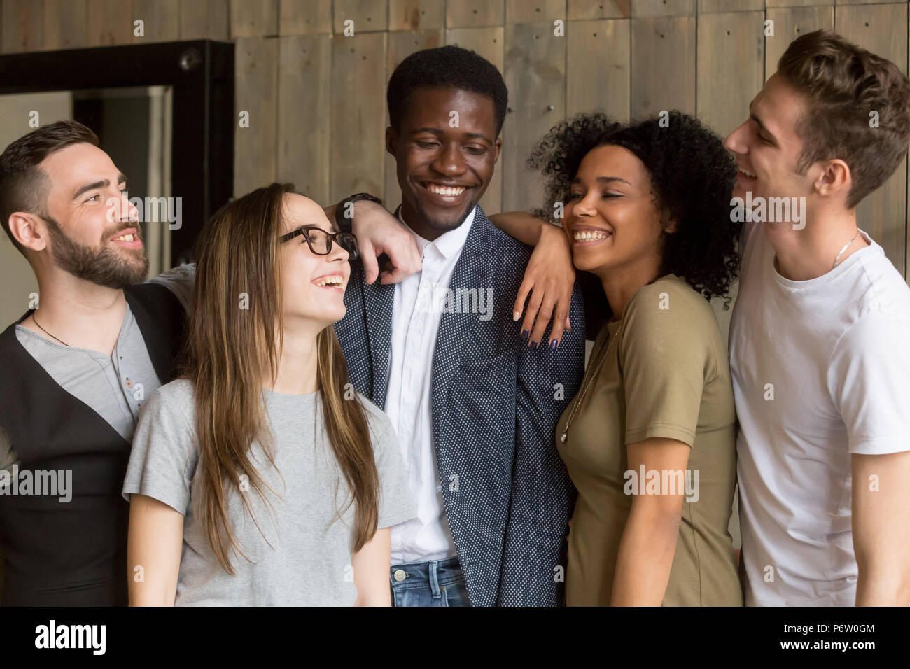 Smiling millennial colleagues having fun together in coffeshop Stock Photo