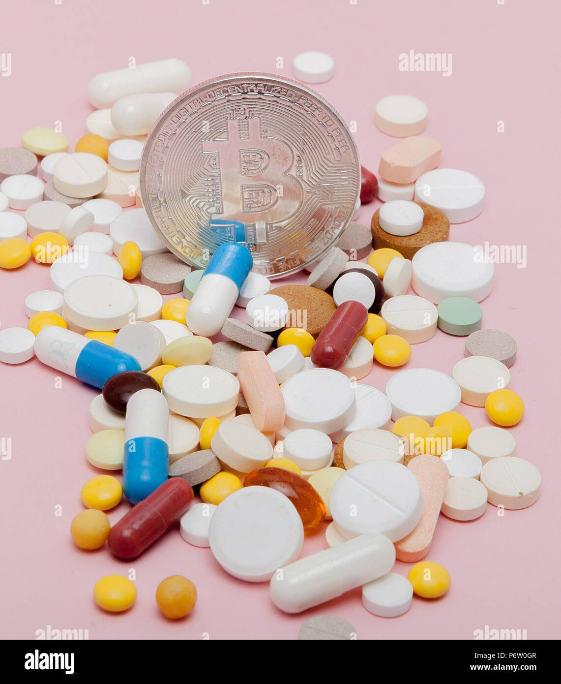 Bitcoin and pills on a pink background. Bitcoin as a medicine for the  economy. Cryptocurrency bitcoin as a payment option for medicines Stock  Photo - Alamy