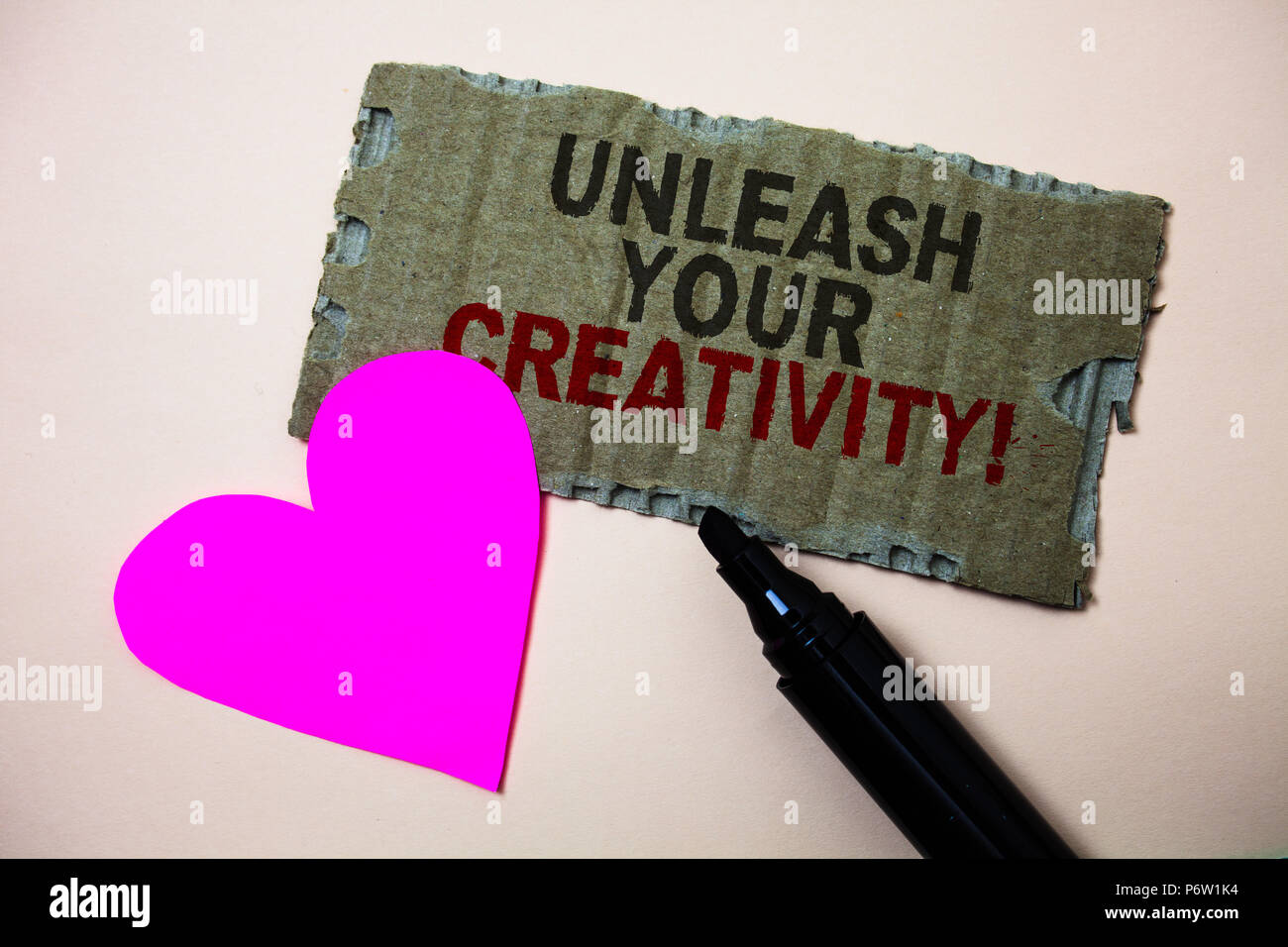 Text sign showing Unleash Your Creativity Call. Conceptual photo Develop Personal Intelligence Wittiness Wisdom Brown paperboard rough ideas message h Stock Photo