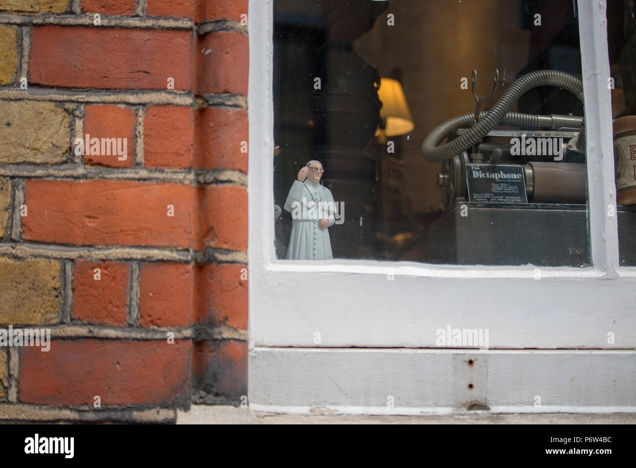 A bobble-head Pope waves from a window in London Stock Photo