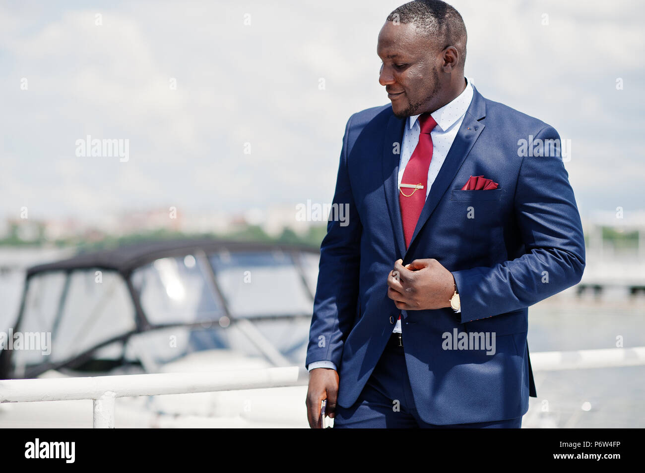 African american happy successful man at suit against yacht. Rich black ...