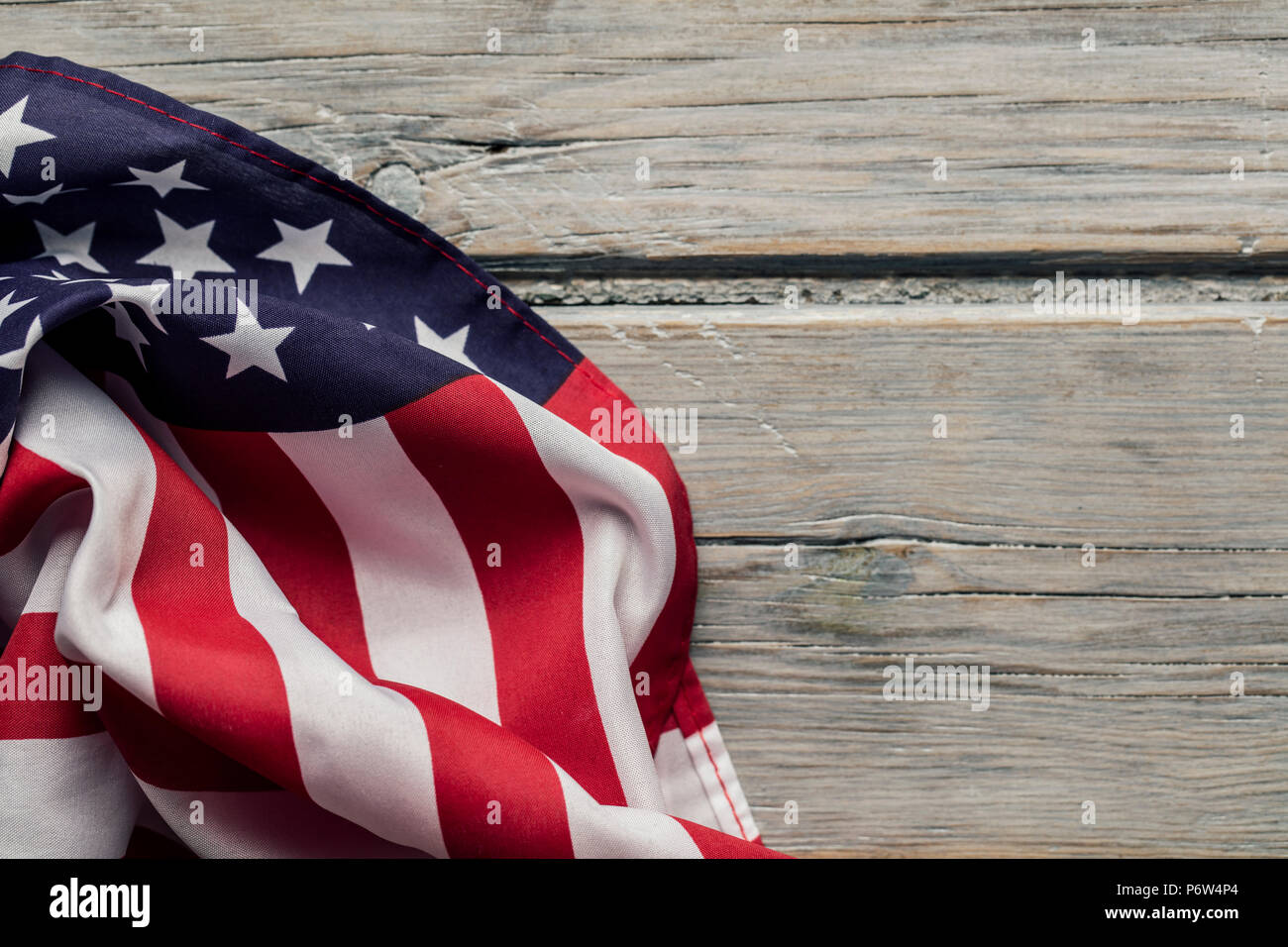 American stars and stripes flag on a white wooden plank background ...