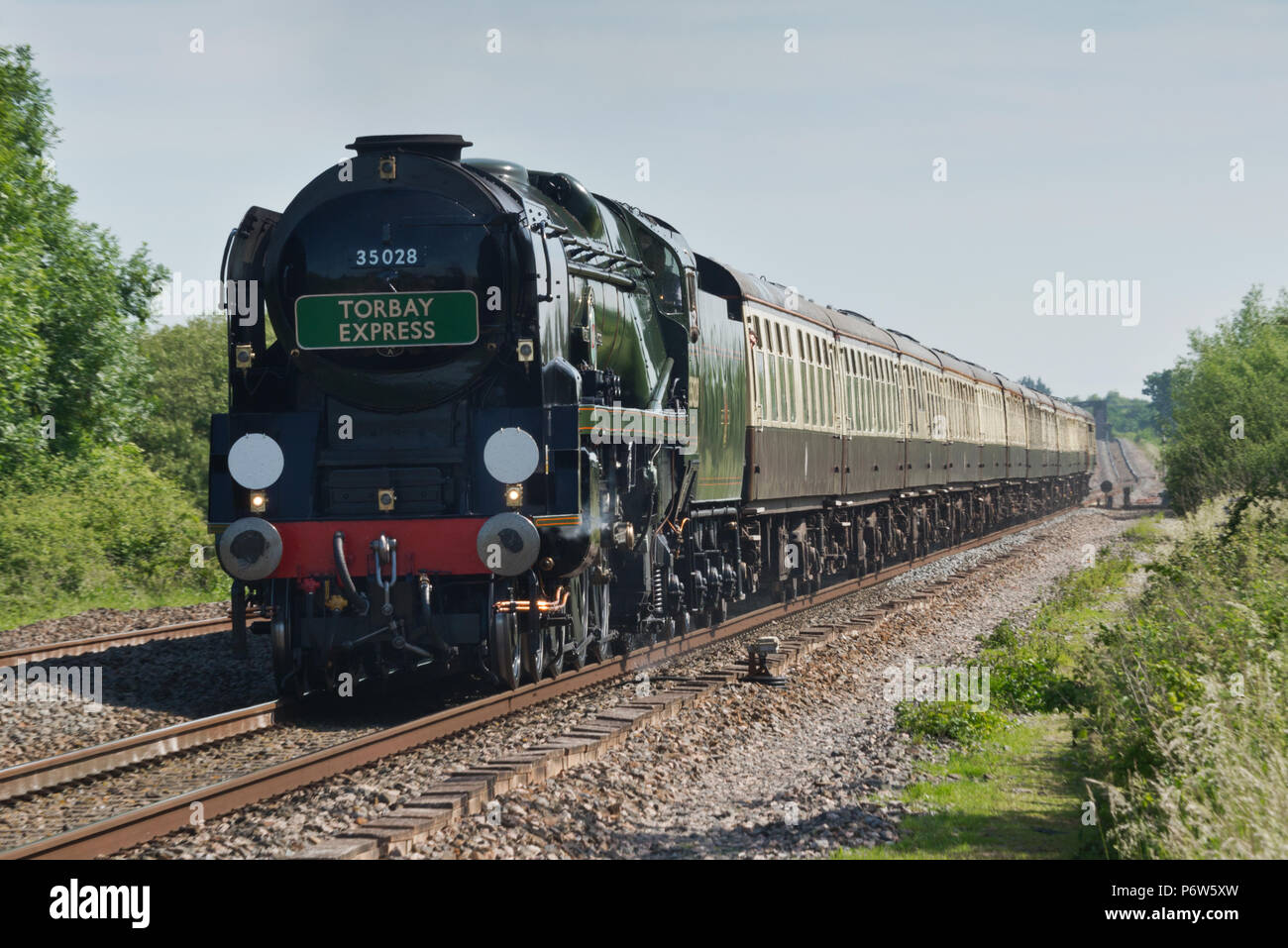 'Clan Line' a Southern Railways Merchant Navy Class 4-6-2 steam locomotive pulling the 'Torbay Express' at Cogload Junction near Taunton in Somerset Stock Photo