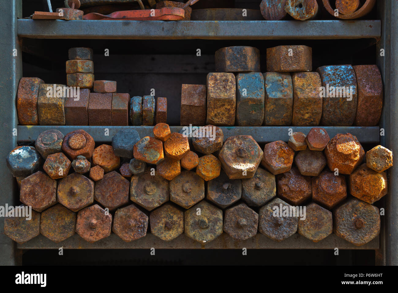 Old rusty and corroded nuts bolts etc in a rack outside the Engine