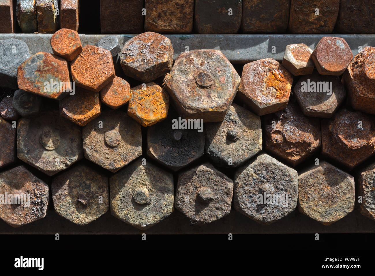 Old rusty and corroded nuts bolts etc in a rack outside the Engine