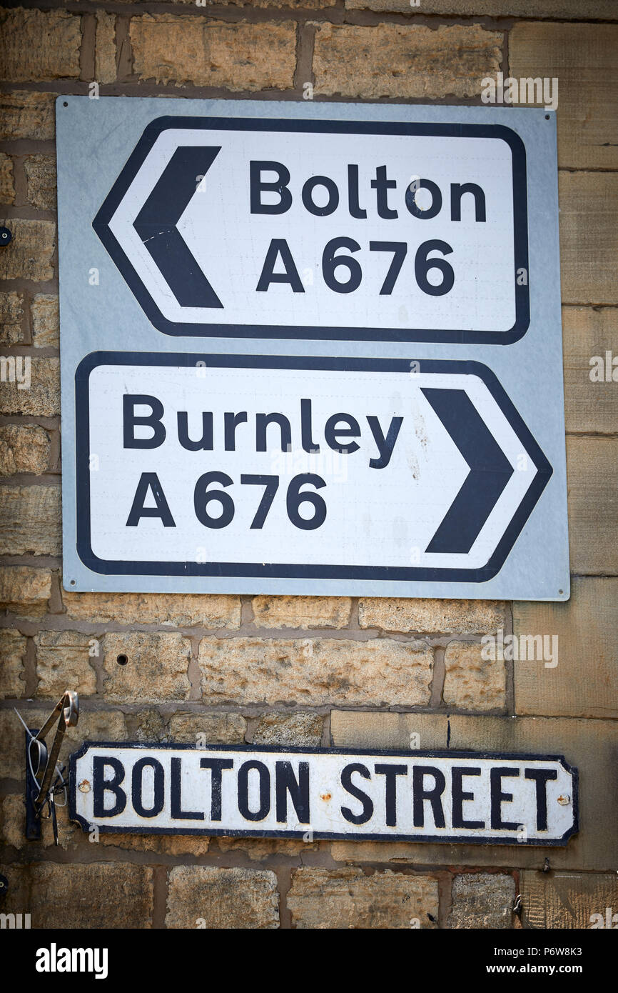 Highways road signs Bolton A676, and Burnley on  Bridge Street, Bolton street junction , Ramsbottom village, Lancashire. Stock Photo