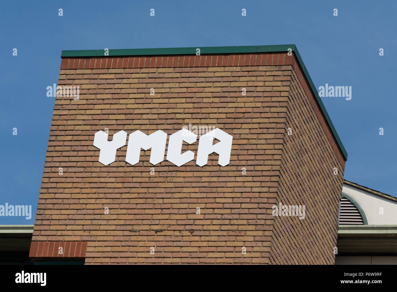Sign on exterior of YMCA (Young Mens Christian Association) in Guildford town in Surrey, UK Stock Photo