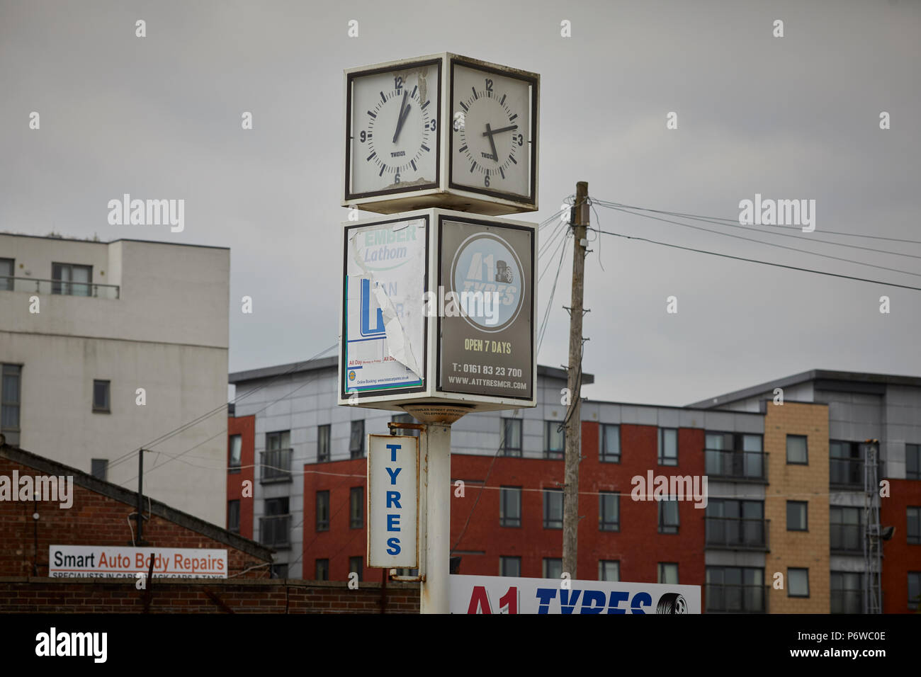 A1 tyres 87 Rochdale Road  Collyhurst square cube clock at the entrance Stock Photo
