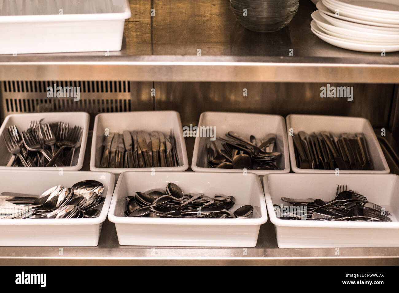 All steel industrial kitchen with burners and utensils Stock Photo - Alamy