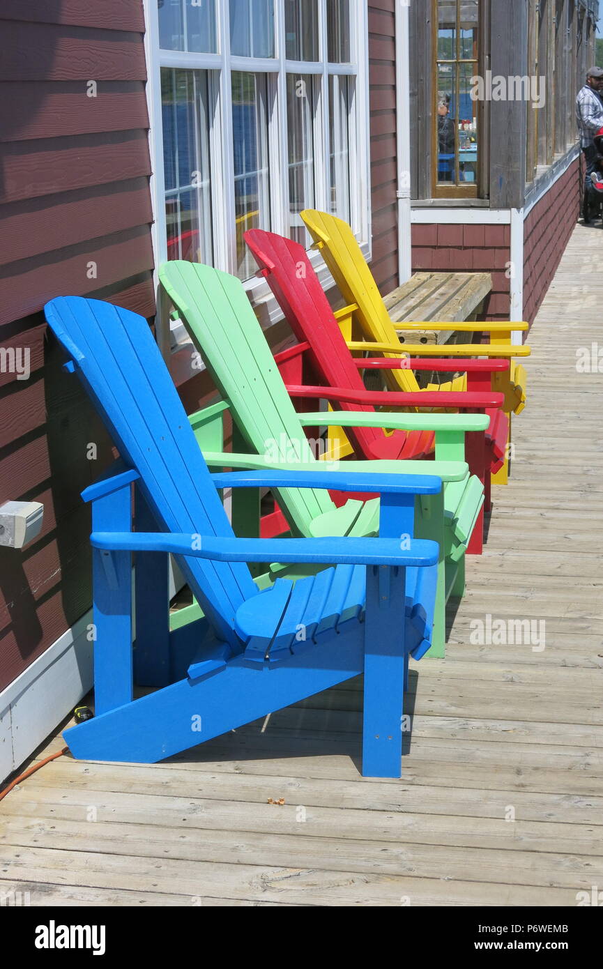 A row of brightly coloured Adirondack chairs at Cable Wharf, Halifax