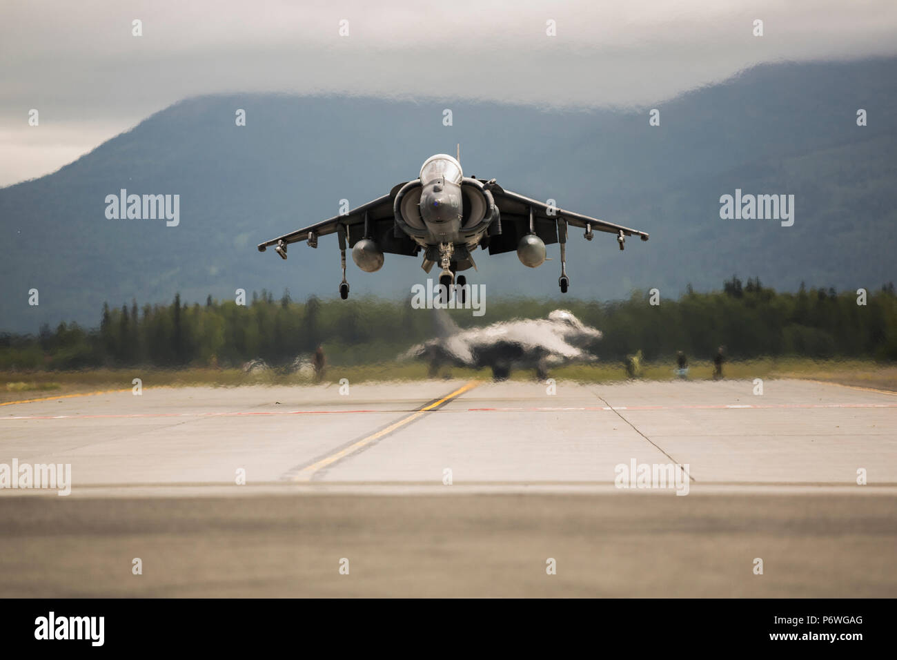 U.S. Marines assigned to Marine Attack Squadron (VMA) 214 participate in the 2018 Arctic Thunder Air Show at Joint Base Elmendorf-Richardson, Alaska, June 29, 2018. VMA-214 conducted a flyby and hover demonstration with their AV-8B Harrier during the air show. (U.S. Marine Corps photo by Lance Cpl. Sabrina Candiaflores) Stock Photo