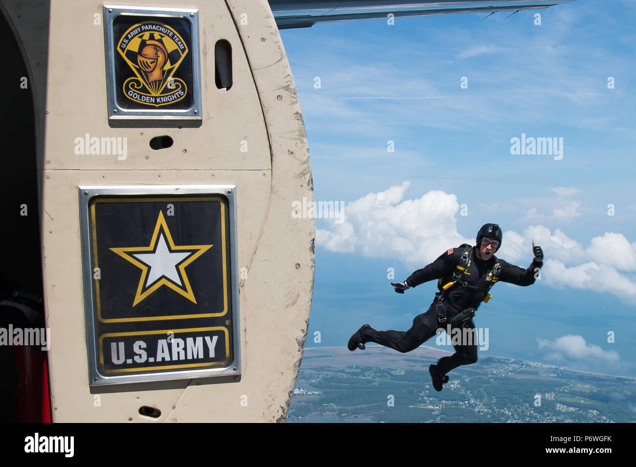 A U.S. Army Golden Knights gold demonstration team member jumps out of an aircraft during AirPower Over Hampton Roads JBLE Air and Space Expo at Joint Base Langley-Eustis, Virginia, May 20, 2018. The Golden Knights have been performing for over fifty-nine years. (U.S. Air Force photo by Airman 1st Class Tristan Biese) Stock Photo