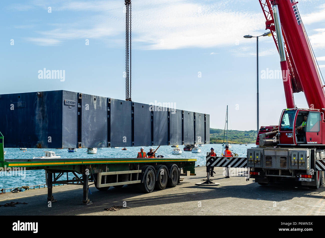 Schull, West Cork, Ireland. 3rd July, 2018. Contractors lift a section of the new pontoon into the water in Schull Harbour. The whole project will take approximately 4 weeks and will cost in the region of €800,000. Credit: Andy Gibson/Alamy Live News. Stock Photo