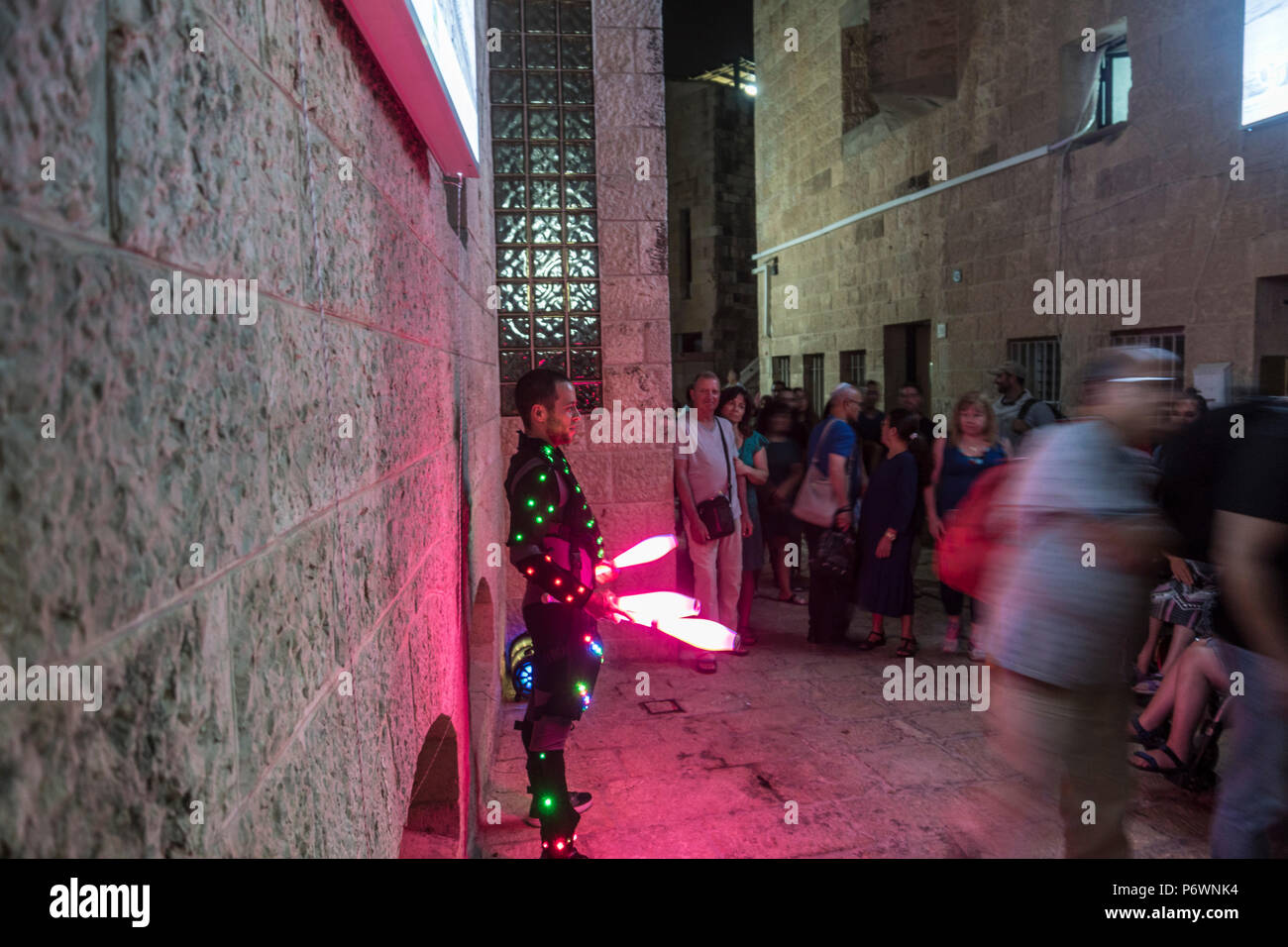 Jerusalem, Israel. 2nd July, 2018. A man juggling glowing clubs during the 2018 Festival of lights. This is the 10th anniversary of the festival, festival, israel, jerusalem, Jerusalem. The Festival of Lights in the Old city, jewish, which draws hundreds of thousands of visitors to the old city of Jerusalem, which is lit by many light sculptures and shows Credit: Yagil Henkin/Alamy Live News Stock Photo