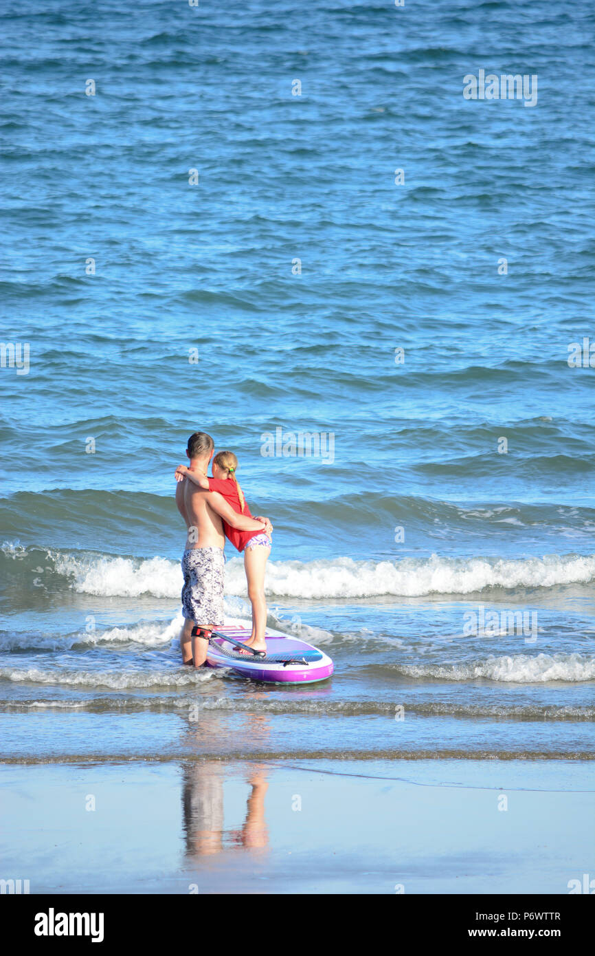 Sandown, Isle of Wight, UK. 3rd July 2018. Paddle boarders and children's school parties cool off after another hot day on the beach heralding the UK's continuing heat wave. Photo at Sandown, Isle of Wight, UK, July 2nd 2018. Credit Matthew Blythe/Alamy Live News. Stock Photo