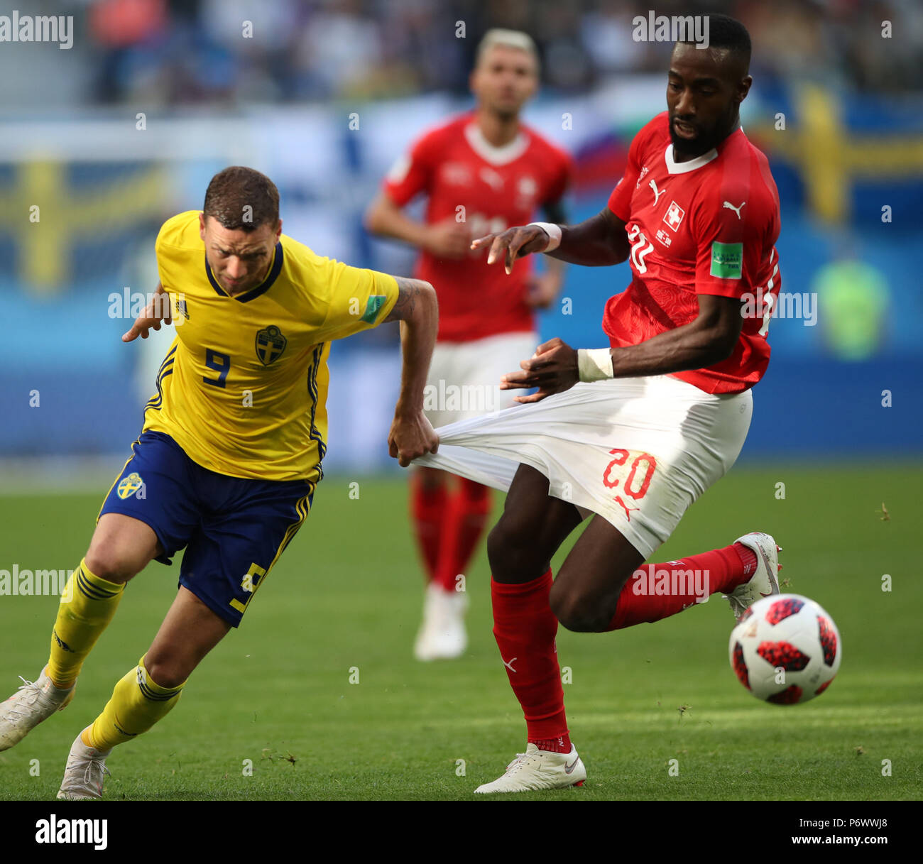 Saint Petersburg, Russia. 3rd July, 2018. Johan Djourou (R) of Switzerland vies with Marcus Berg of Sweden during the 2018 FIFA World Cup round of 16 match between Switzerland and Sweden in Saint Petersburg, Russia, July 3, 2018. Sweden won 1-0 and advanced to the quarter-final. Credit: Wu Zhuang/Xinhua/Alamy Live News Stock Photo