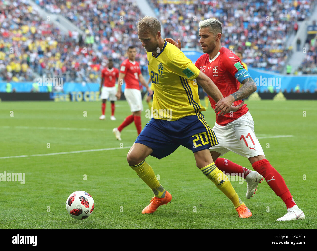 Saint Petersburg, Russia. 3rd July, 2018. Valon Behrami (R) of Switzerland vies with Ola Toivonen of Sweden during the 2018 FIFA World Cup round of 16 match between Switzerland and Sweden in Saint Petersburg, Russia, July 3, 2018. Sweden won 1-0 and advanced to the quarter-final. Credit: Cao Can/Xinhua/Alamy Live News Stock Photo