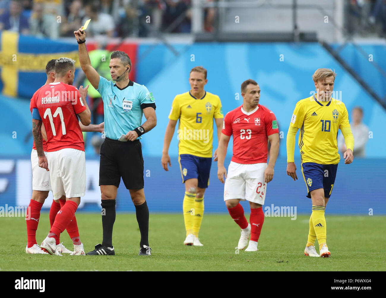 Saint Petersburg, Russia. 3rd July, 2018. The referee gives a yellow card to Valon Behrami (2nd L) of Switzerland during the 2018 FIFA World Cup round of 16 match between Switzerland and Sweden in Saint Petersburg, Russia, July 3, 2018. Sweden won 1-0 and advanced to the quarter-final. Credit: Cao Can/Xinhua/Alamy Live News Stock Photo