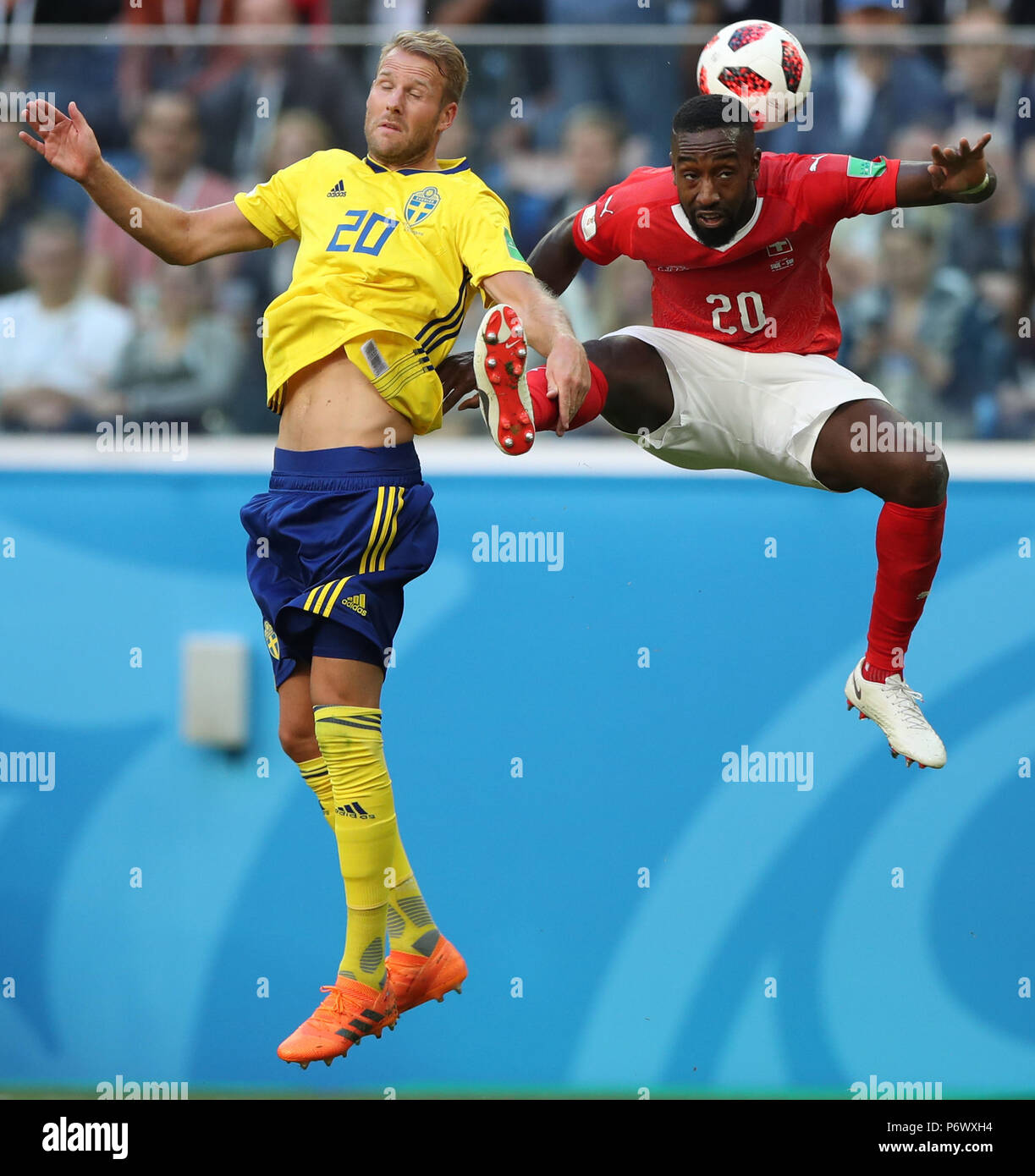Saint Petersburg, Russia. 3rd July, 2018. Johan Djourou (R) of Switzerland vies with Ola Toivonen of Sweden during the 2018 FIFA World Cup round of 16 match between Switzerland and Sweden in Saint Petersburg, Russia, July 3, 2018. Sweden won 1-0 and advanced to the quarter-final. Credit: Wu Zhuang/Xinhua/Alamy Live News Stock Photo