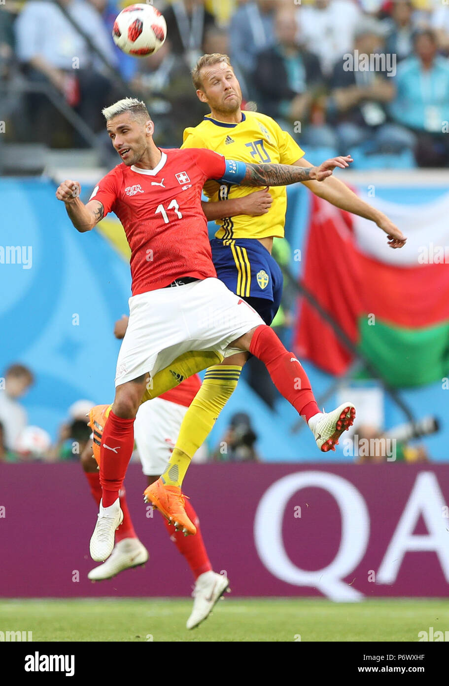 Saint Petersburg, Russia. 3rd July, 2018. Valon Behrami (L) of Switzerland vies with Ola Toivonen of Sweden during the 2018 FIFA World Cup round of 16 match between Switzerland and Sweden in Saint Petersburg, Russia, July 3, 2018. Sweden won 1-0 and advanced to the quarter-final. Credit: Xu Zijian/Xinhua/Alamy Live News Stock Photo