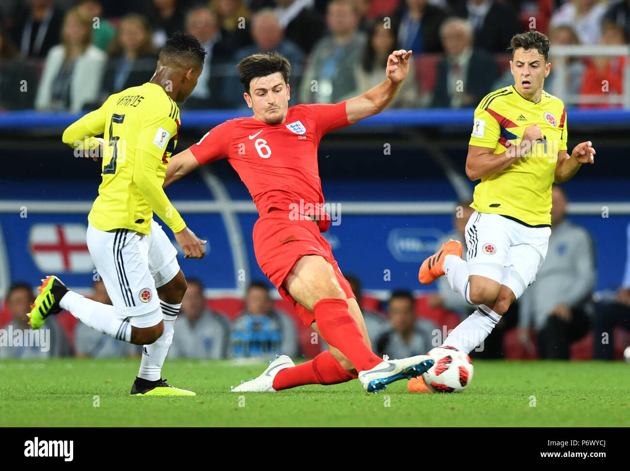 Moscow, Russia. 3rd July, 2018. Harry Maguire (C) of England vies with Wilmar Barrios (L) of Colombia during the 2018 FIFA World Cup round of 16 match between England and Colombia in Moscow, Russia, July 3, 2018. Credit: Du Yu/Xinhua/Alamy Live News Stock Photo