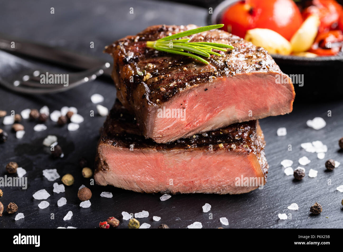 Closeup of steak Top Blade roasting medium ready to eat on dark stone