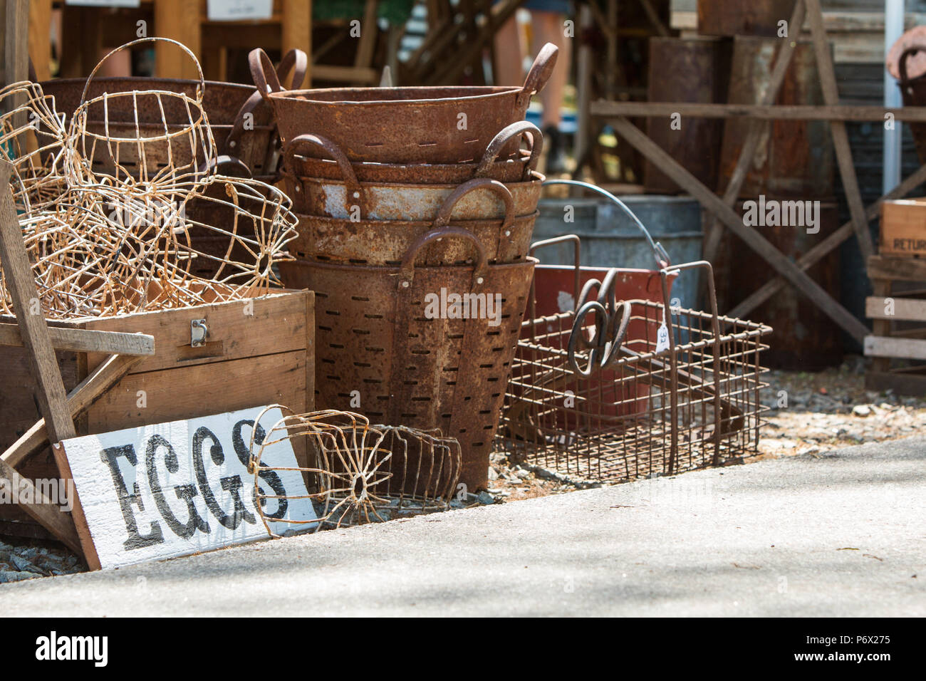 Vintage metal egg baskets sit on sale at antique festival Stock