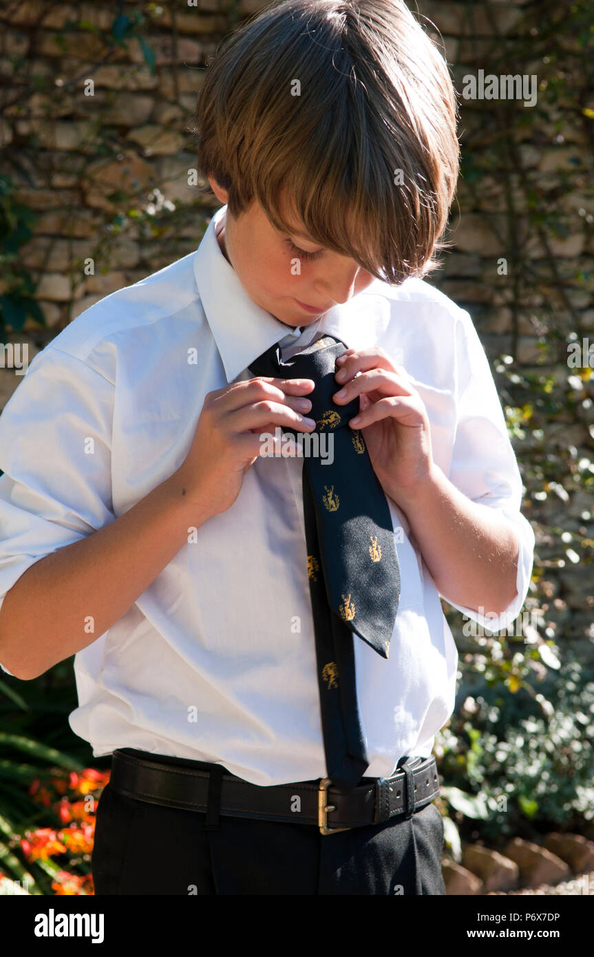 Schoolboy tying his school tie Stock Photo Alamy