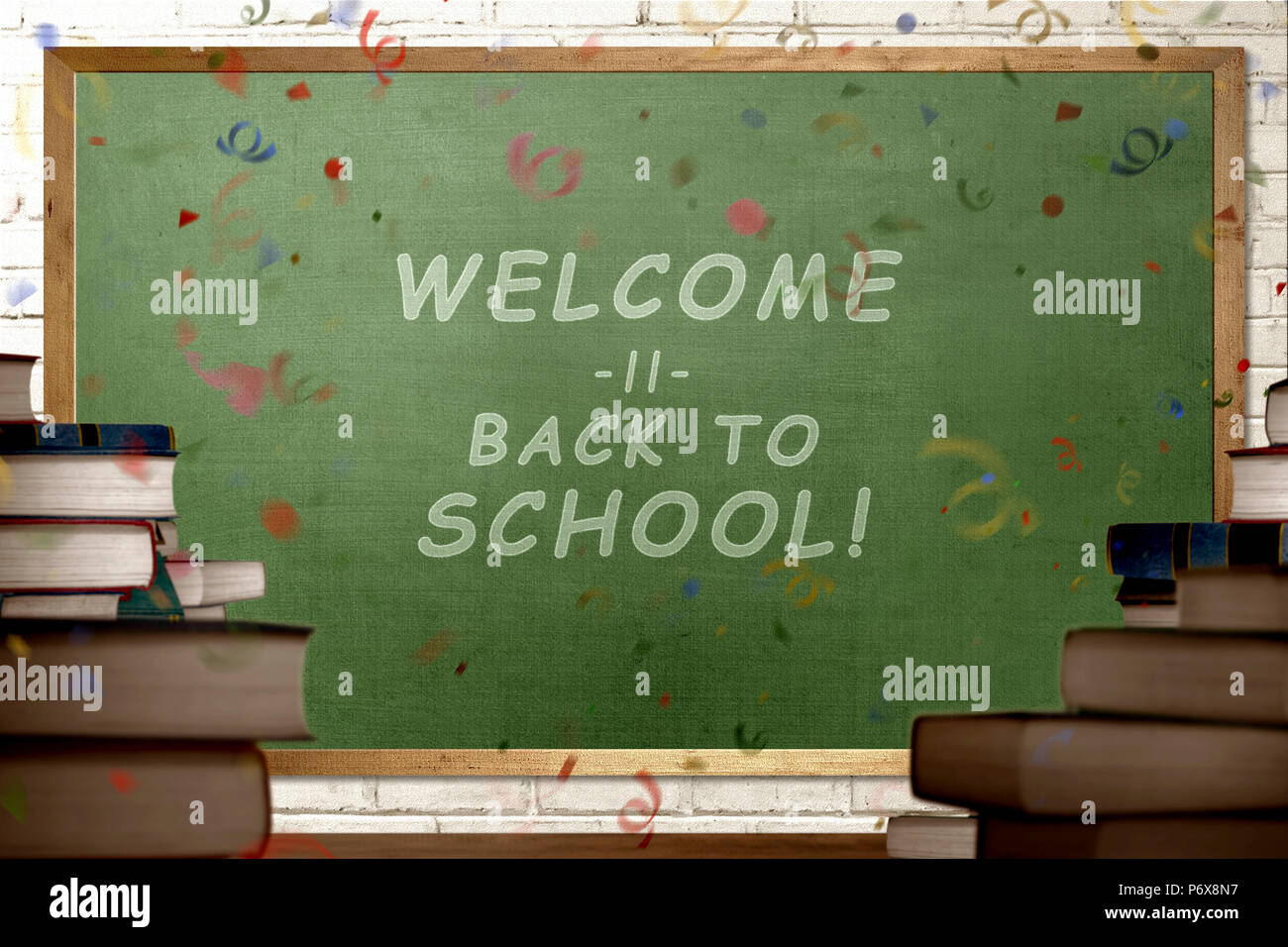 Stack of books with Welcome back to school message on the chalkboard ...