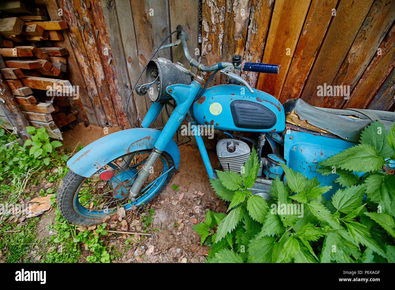 An old abandoned motorcycle stand near a fence in the village Stock ...