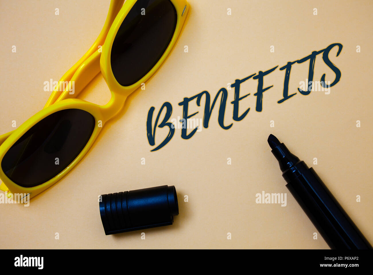 Writing note showing  Benefits. Business photo showcasing Advantage Insurance Compensation Interest Revenue Gain Aid Ideas messages beige background b Stock Photo