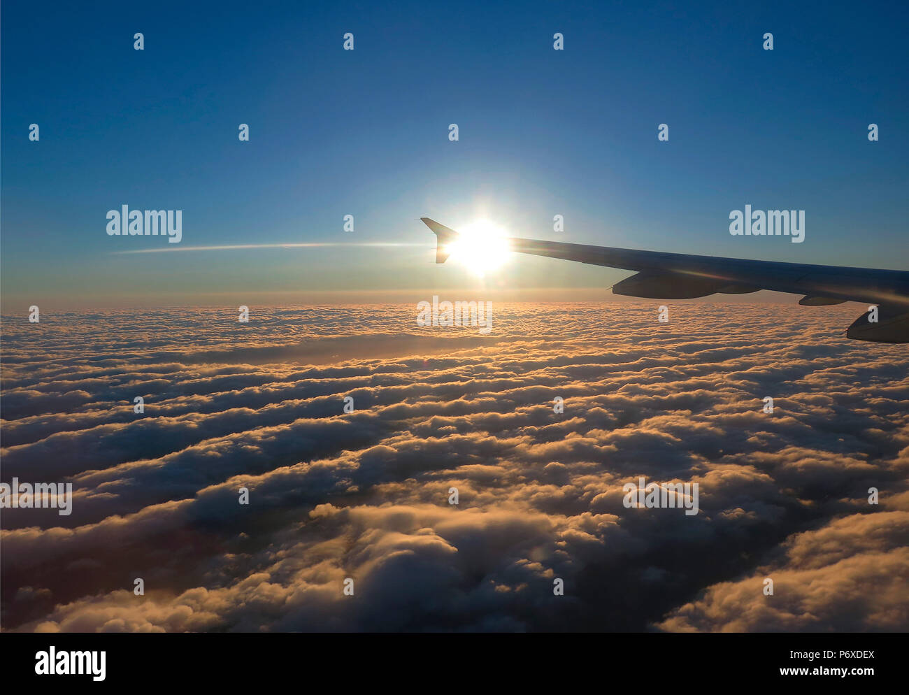 wing of airplane above the clouds Stock Photo