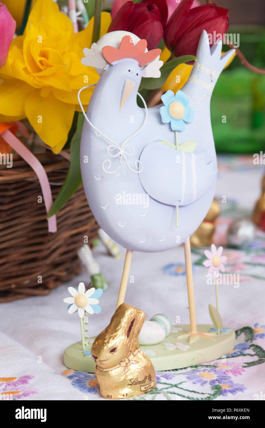 Beautiful spring flowers in a basket with Easter decorations Stock Photo