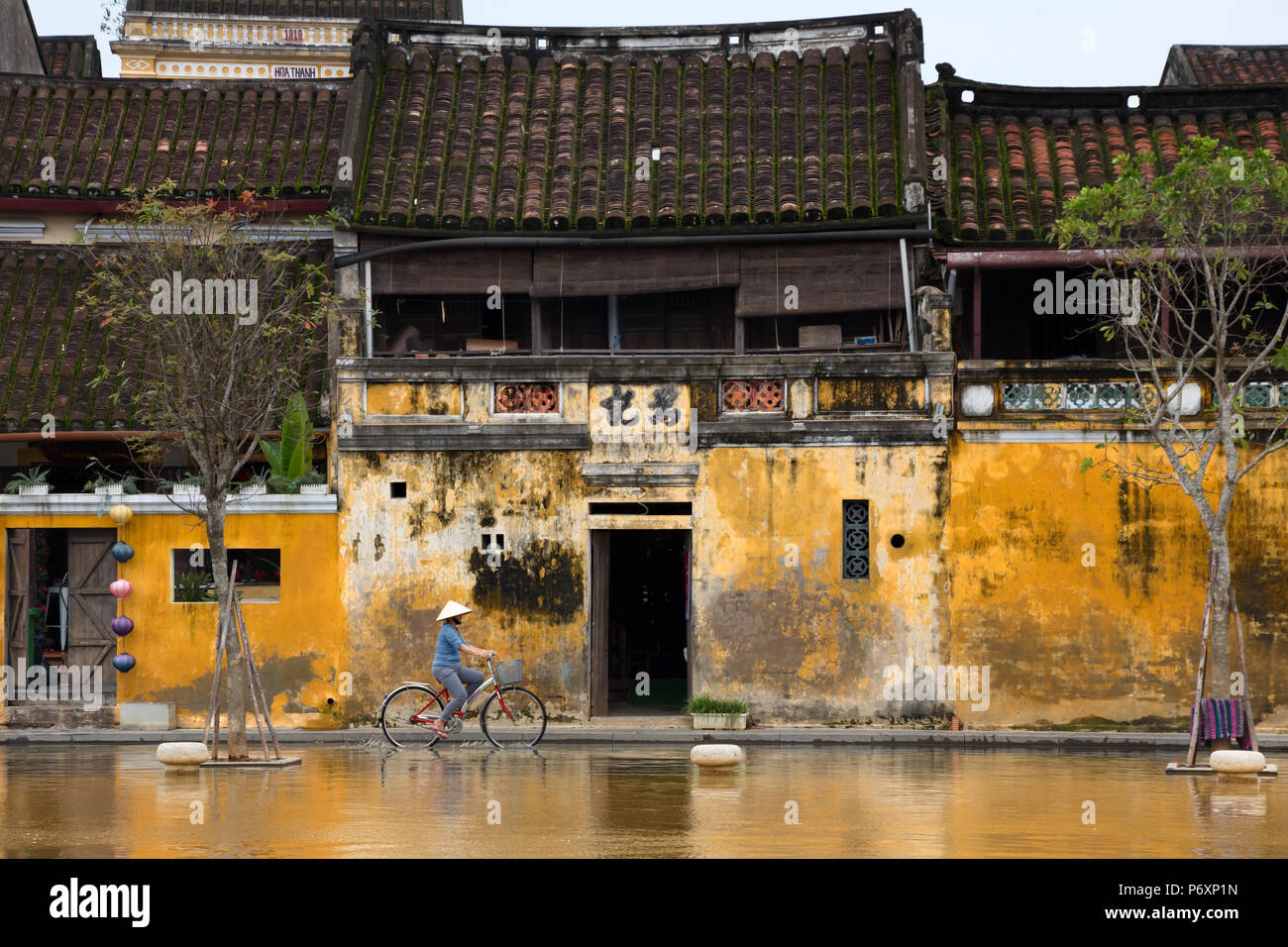 Streets of Hoi An , Vietnam - people and architecture Stock Photo