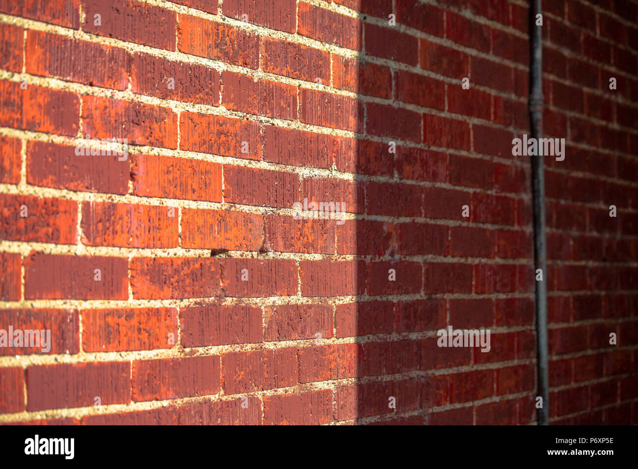 Brick wall with sun and shade for half Stock Photo