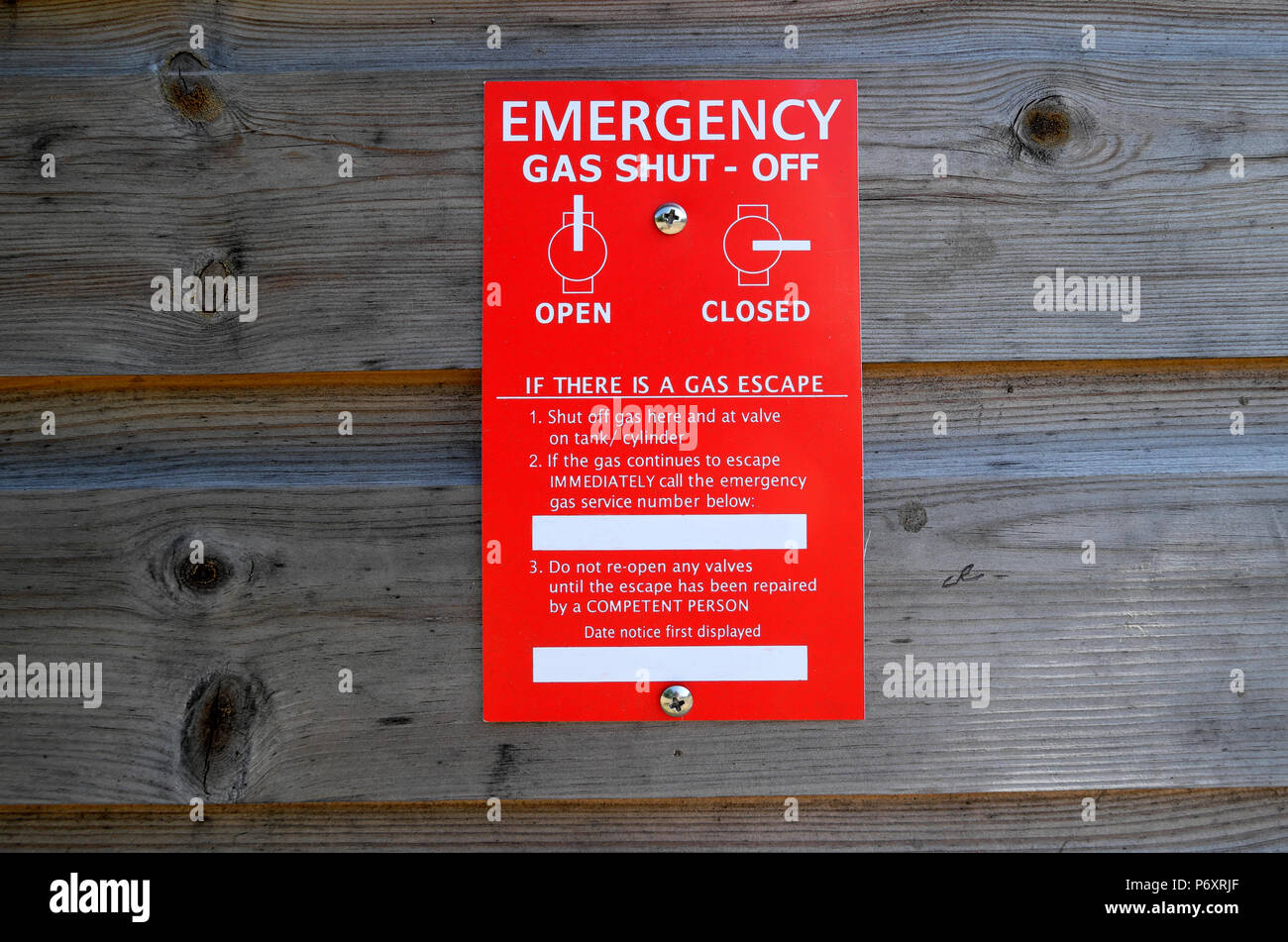 An emergency opso over pressure shut - off warning on a changeover valve for LPG gas bottles on exterior wooden cabinet in Wales UK    KATHY DEWITT Stock Photo