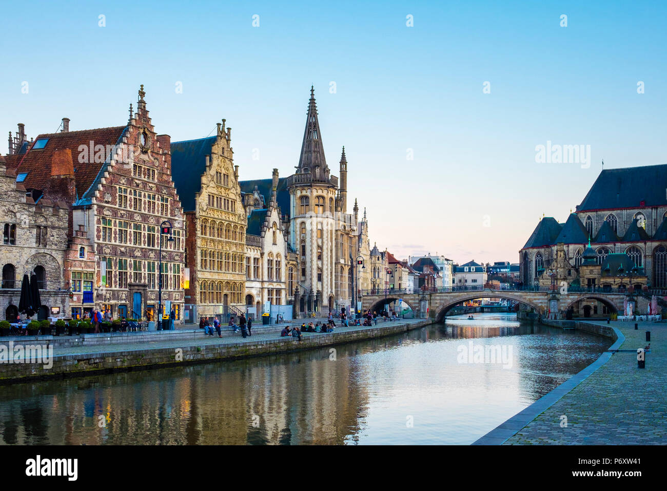 Belgium, Flanders, Ghent (Gent). The Leie River and buildings along Graslei quay at dusk. Stock Photo