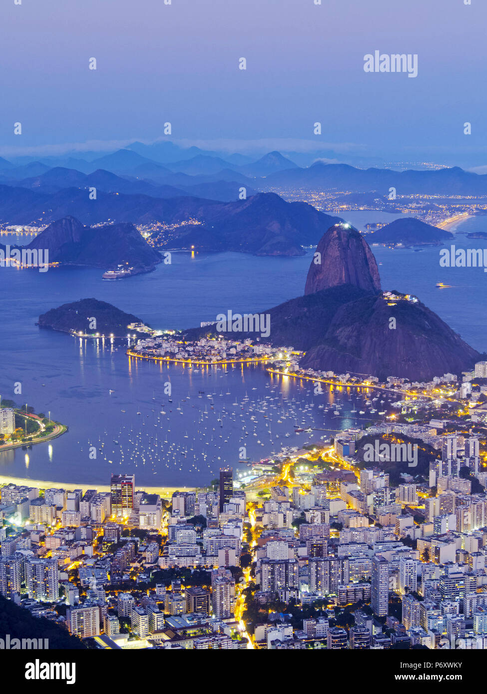 Brazil, State of Rio de Janeiro, City of Rio de Janeiro, Corcovado Mountain, Twilight view of the city with Sugarloaf Mountain and Guanabara Bay. Stock Photo