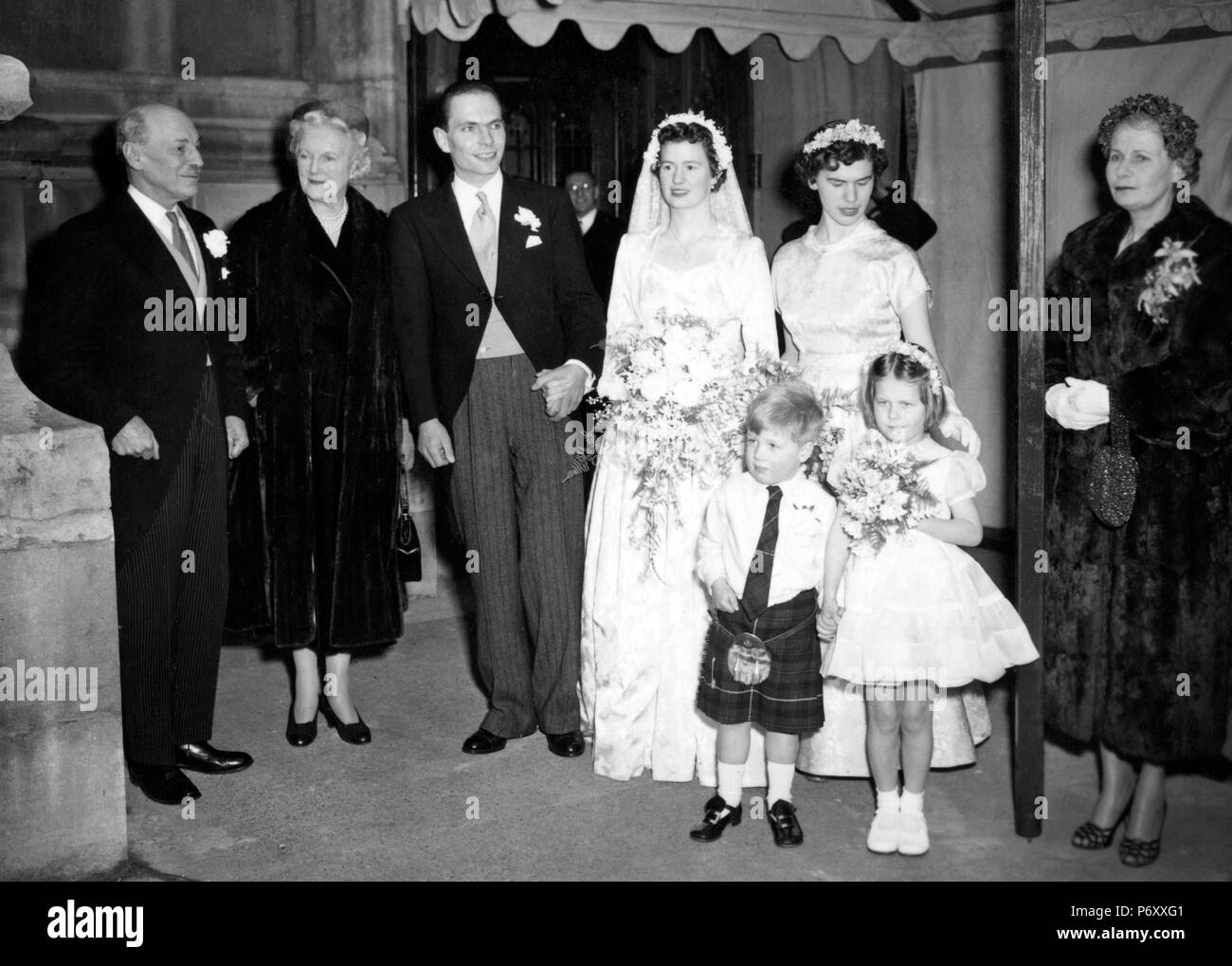 (L-R) Right Hon. Clement Attlee, father often groom, guest Lady Churchill, wife of the Prime Minister, the bridegroom, Martin Richard Attlee and his bride, the former Anne Barbara Henderson, bridal attendants and Mrs Clement Attlee, the bridegroom's mother. *Neg corrupt, scanned from contact Stock Photo