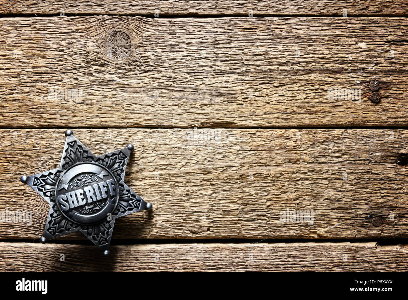Sheriff star on wooden table Stock Photo