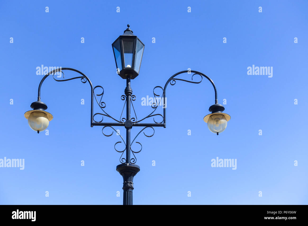 Old fashioned street lights against cloudless blue sky near beach of Port Melbourne. VIC Australia. Stock Photo