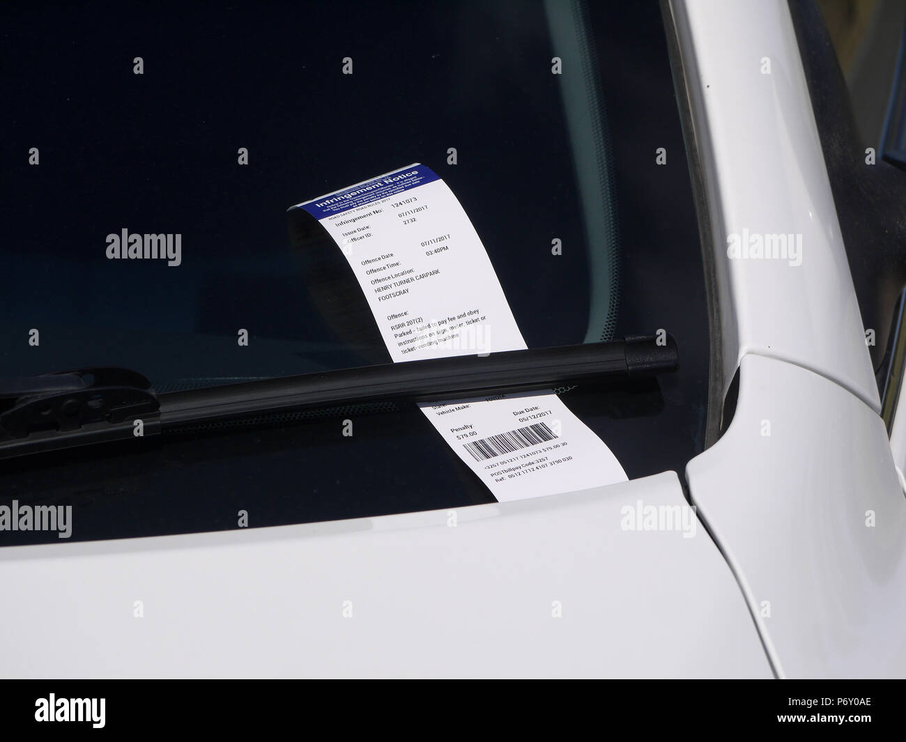 Infringement notice left on windscreen of a parked car. Melbourne, VIC Australia. Stock Photo