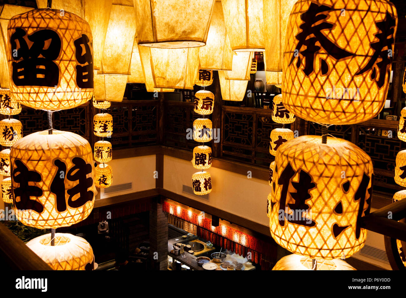 A yellow lantern hanging from the ceiling Stock Photo