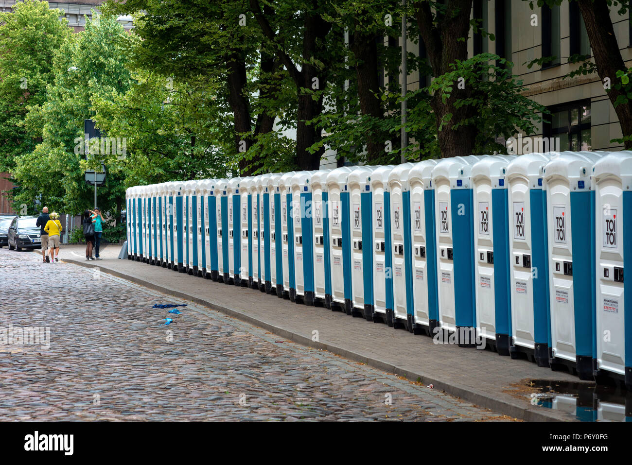 RIGA, LATVIA - JUNE 22, 2018: Summer solstice market. On the edge of City Street there is a row with portable public toilets. Stock Photo
