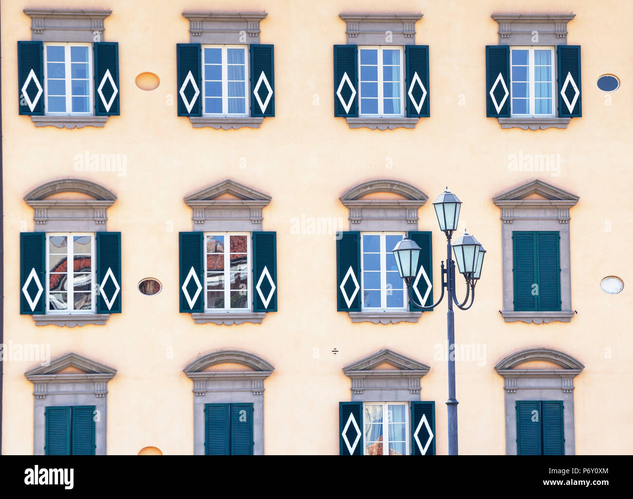 Traditional house decorated with Pisa symbol on the bank of Arno River, Pisa, Tuscany, Italy, Europe Stock Photo