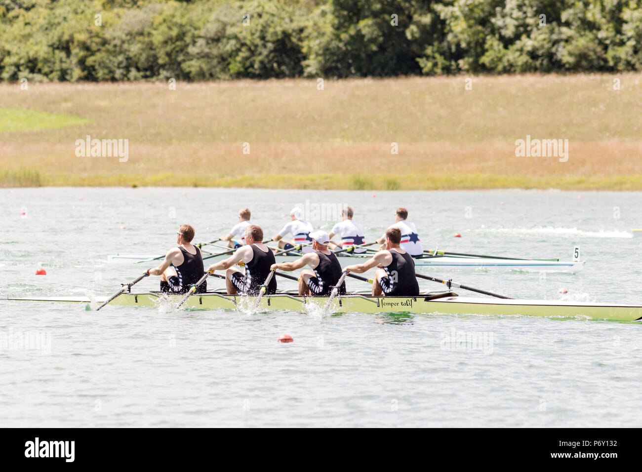 Rowers in rowing boats on the tranquil lake Stock Photo Alamy
