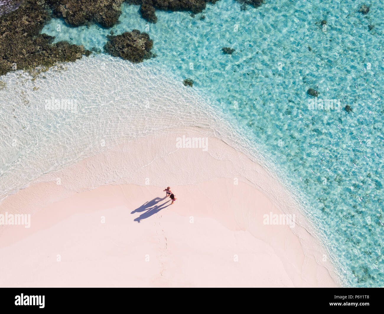 Aerial drone view of adult couple on a sandy beach, Maldives (MR) Stock Photo