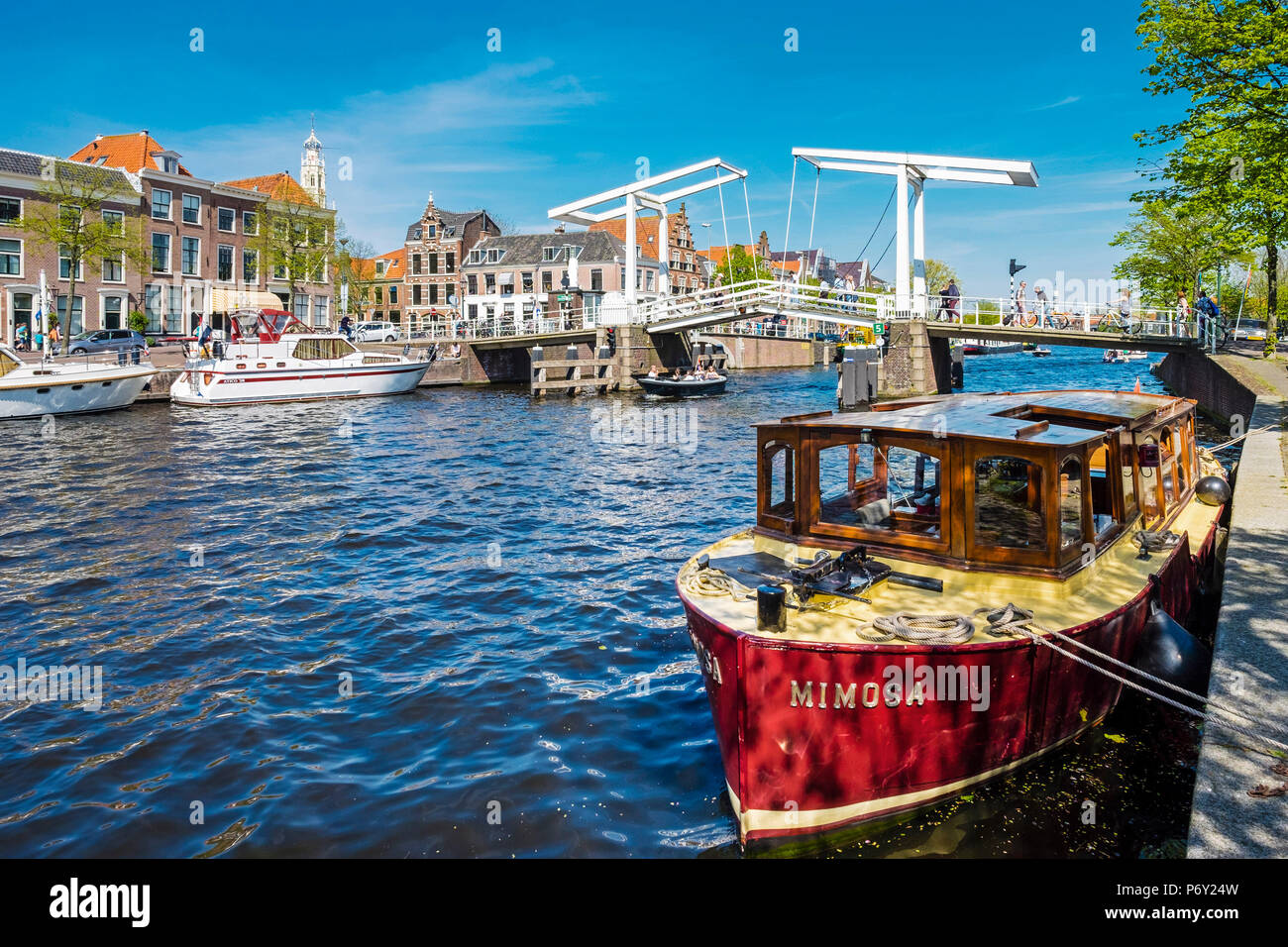 Netherlands, North Holland, Haarlem. Gravestenenbrug drawbridge and boats on the Spaarne River. Stock Photo