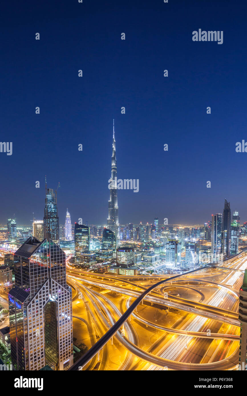 UAE, Dubai, Downtown Dubai, eleavted view over Sheikh Zayed Road and Burj Khalifa Tower, world's tallest building, 2016, dusk Stock Photo