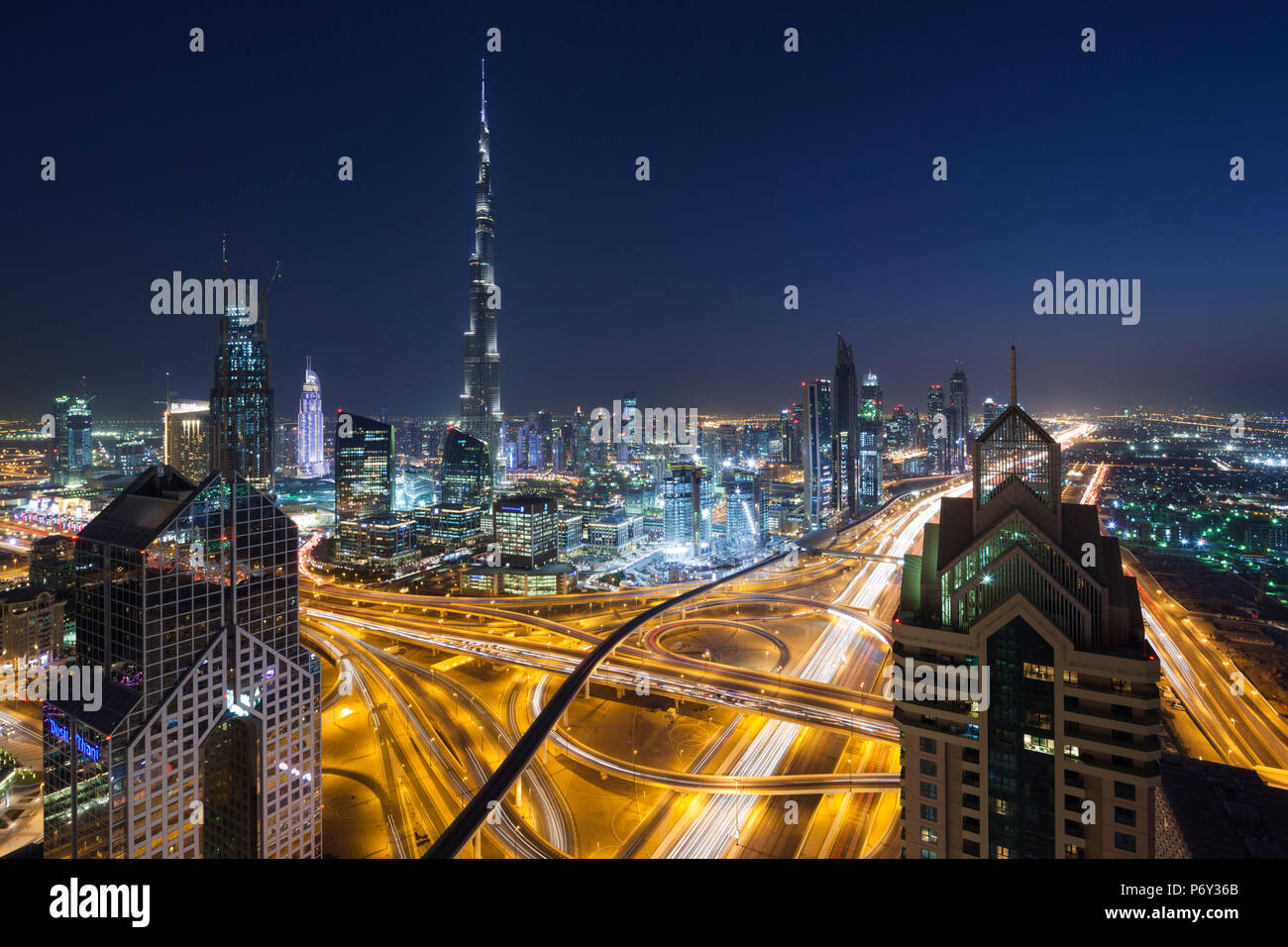 UAE, Dubai, Downtown Dubai, eleavted view over Sheikh Zayed Road and Burj Khalifa Tower, world's tallest building, 2016, dusk Stock Photo
